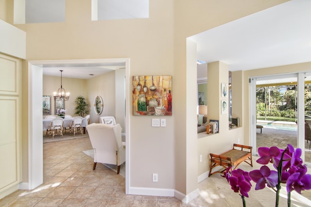 corridor with an inviting chandelier and light tile patterned flooring