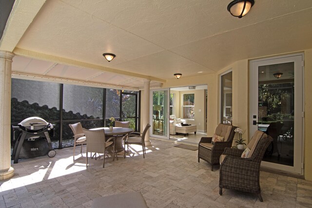 exterior space featuring glass enclosure, french doors, and a patio