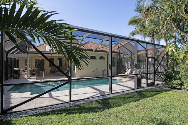 view of pool with a lanai, a yard, and a patio