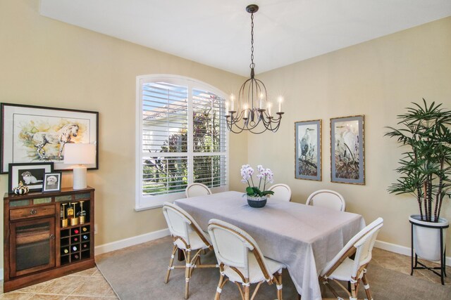 dining area with a high ceiling, ceiling fan with notable chandelier, and plenty of natural light