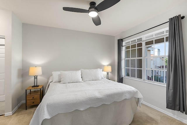 bedroom featuring ceiling fan and light carpet