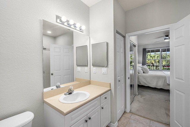 bathroom featuring ceiling fan, tile patterned flooring, vanity, and toilet