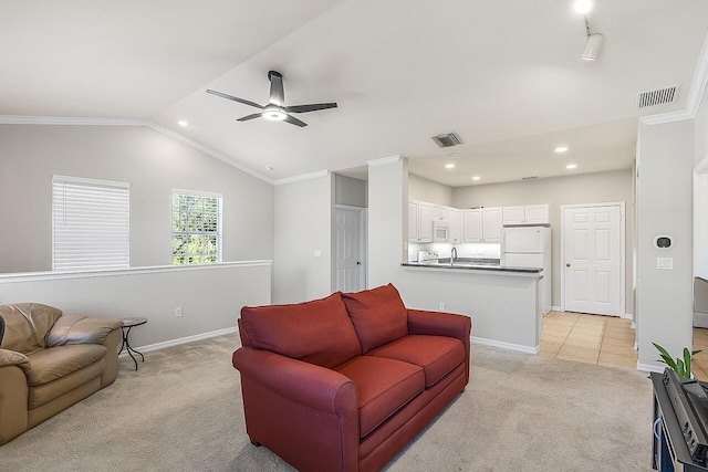 living room featuring light carpet, ornamental molding, ceiling fan, and lofted ceiling