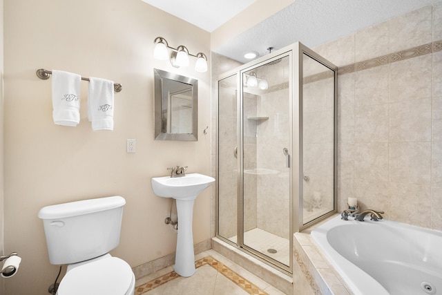 bathroom featuring tile patterned floors, separate shower and tub, a textured ceiling, and toilet