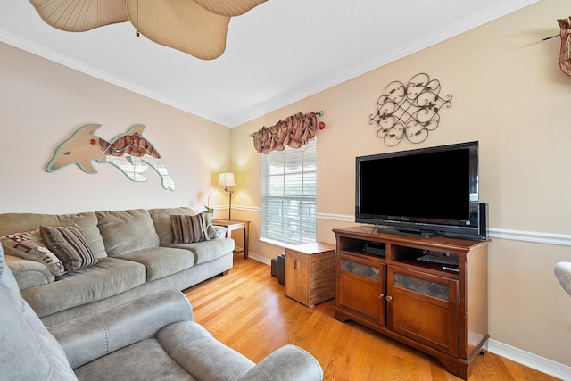 living room featuring light wood-type flooring, ceiling fan, and ornamental molding