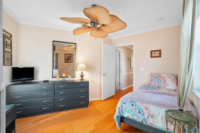 bedroom with ceiling fan, crown molding, and light wood-type flooring