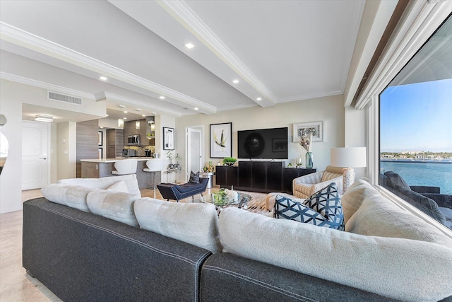 living room with ornamental molding and beamed ceiling