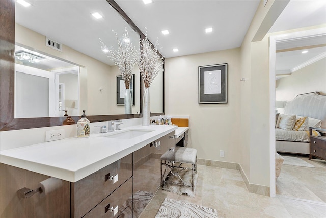 bathroom featuring ornamental molding and vanity