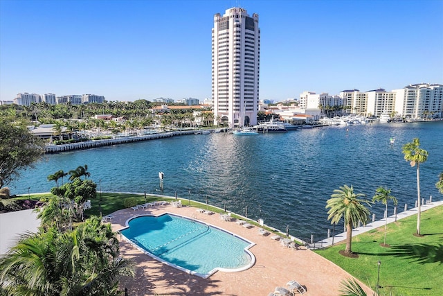 view of pool with a patio and a water view