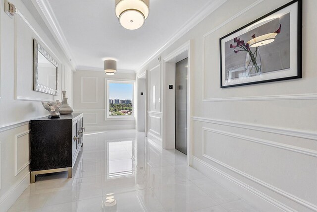 hallway featuring elevator, light tile patterned flooring, and crown molding