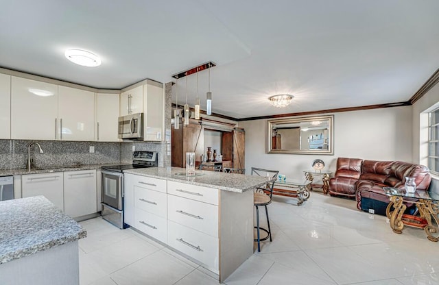 kitchen featuring a kitchen bar, kitchen peninsula, stainless steel appliances, white cabinets, and hanging light fixtures