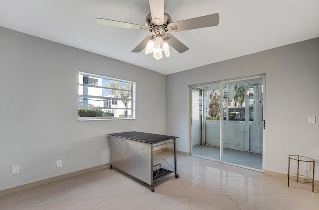 office area with light tile patterned floors and ceiling fan