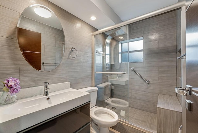 bathroom with vanity, an enclosed shower, tile walls, and toilet