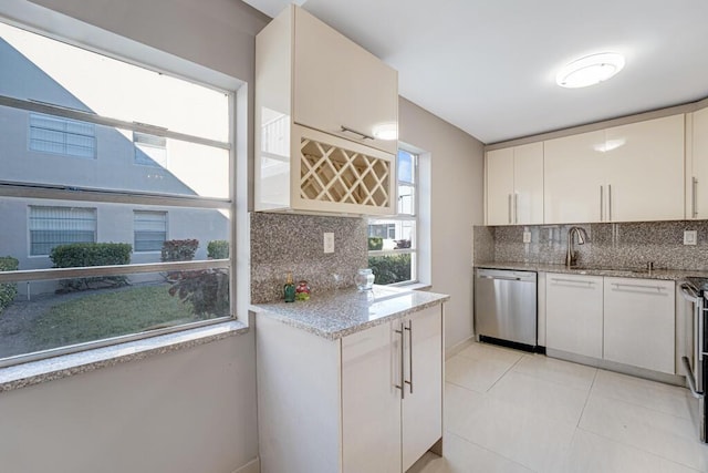 kitchen featuring light tile patterned floors, white cabinetry, backsplash, and appliances with stainless steel finishes