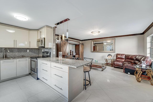 kitchen with stainless steel appliances, light stone counters, kitchen peninsula, decorative light fixtures, and a breakfast bar area