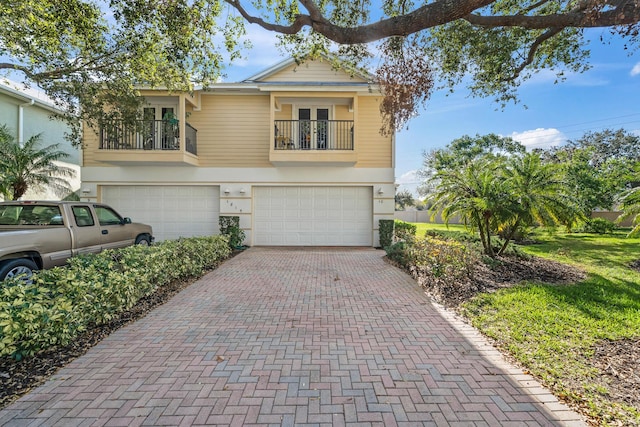 view of front of home featuring a garage and a balcony