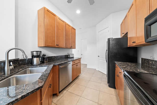 kitchen with ceiling fan, dark stone countertops, black appliances, and sink