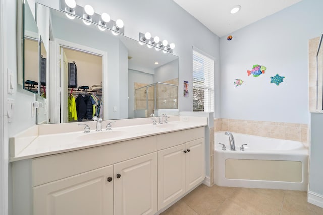 bathroom featuring vanity, tile patterned flooring, and separate shower and tub