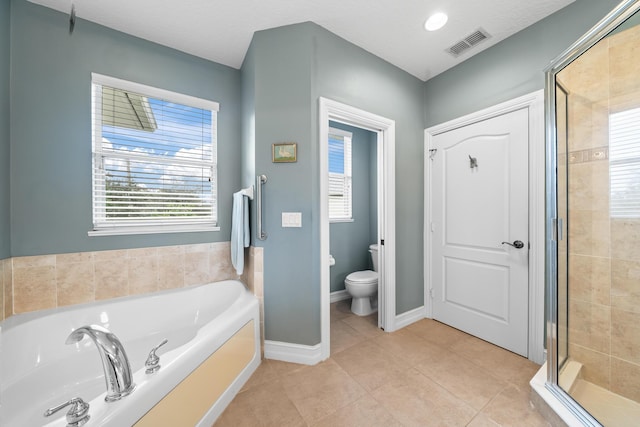 bathroom featuring toilet, plus walk in shower, and tile patterned floors