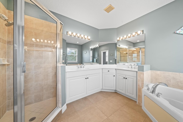 bathroom featuring vanity, tile patterned flooring, and separate shower and tub