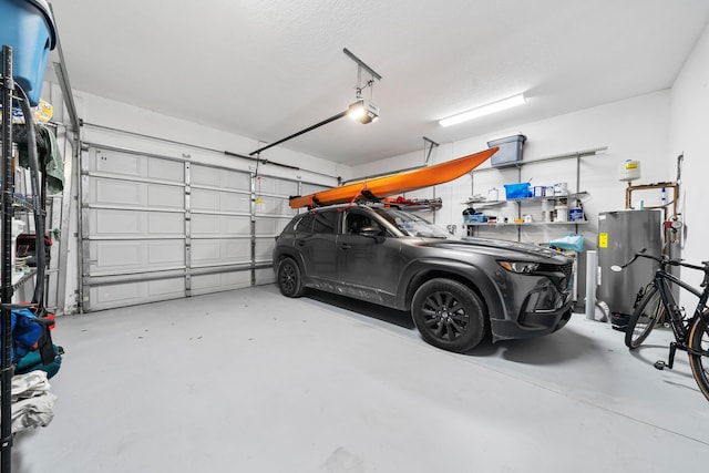 garage with electric water heater and a garage door opener