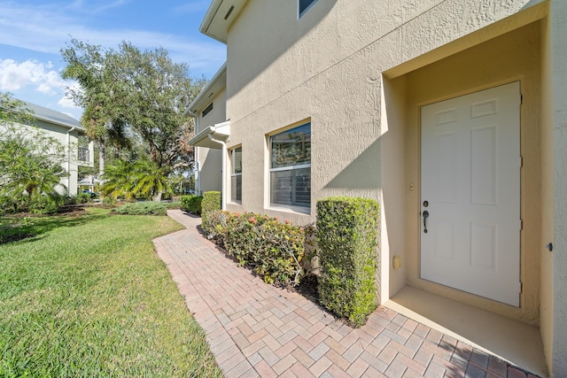 property entrance with a yard