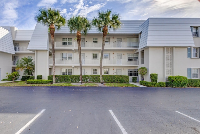 view of property with uncovered parking