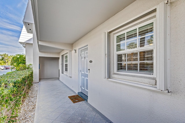 view of exterior entry with stucco siding
