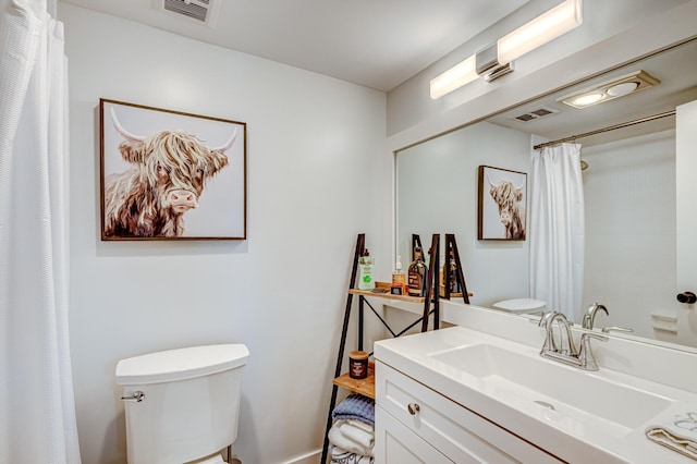 bathroom featuring toilet and vanity