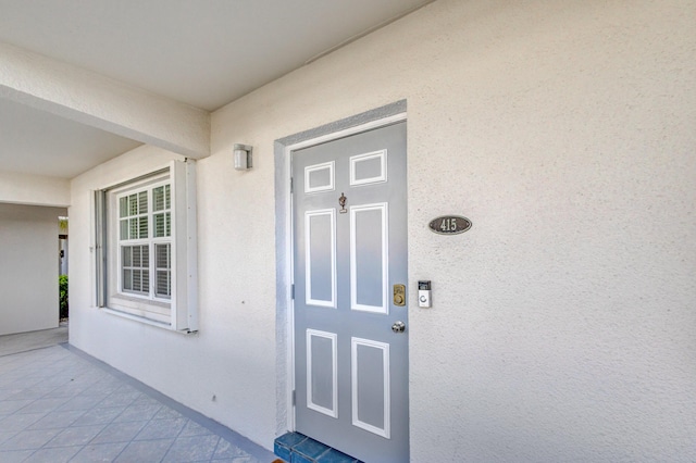 entrance to property with stucco siding