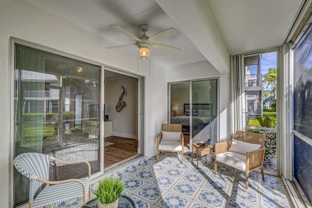 sunroom featuring a ceiling fan