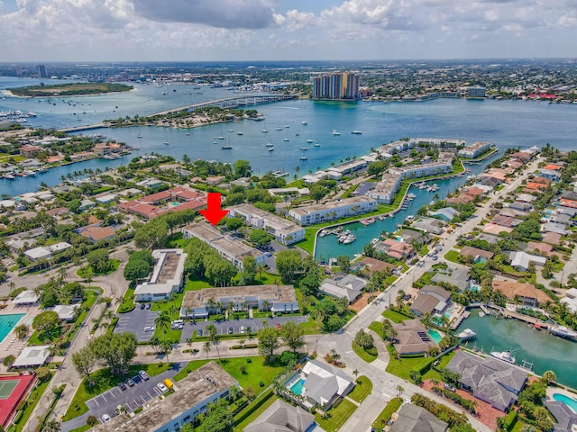 aerial view of property and surrounding area with a large body of water and a notable bridge
