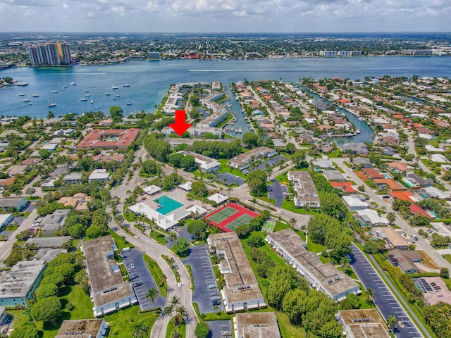 aerial view of property's location with a large body of water and nearby suburban area