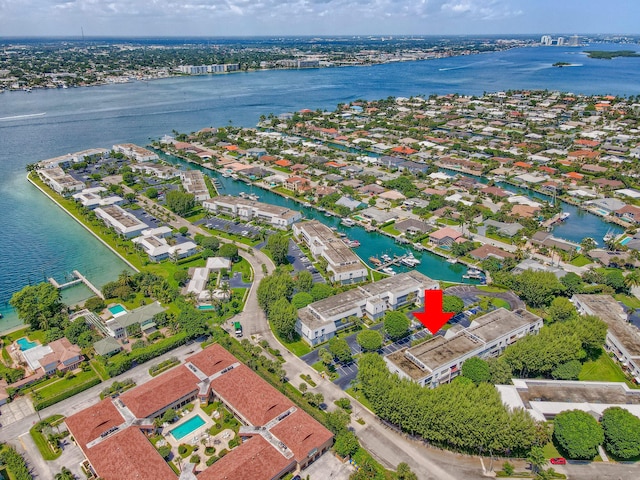 aerial view of property and surrounding area featuring a large body of water and nearby suburban area