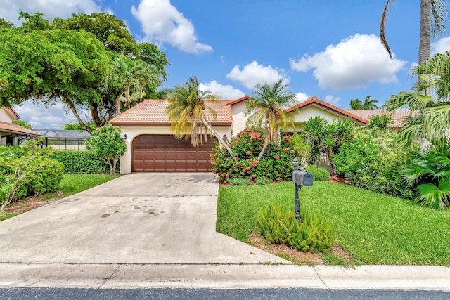 mediterranean / spanish-style house with a garage and a front lawn