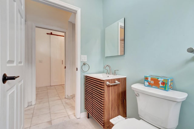 bathroom featuring tile patterned flooring, vanity, and toilet