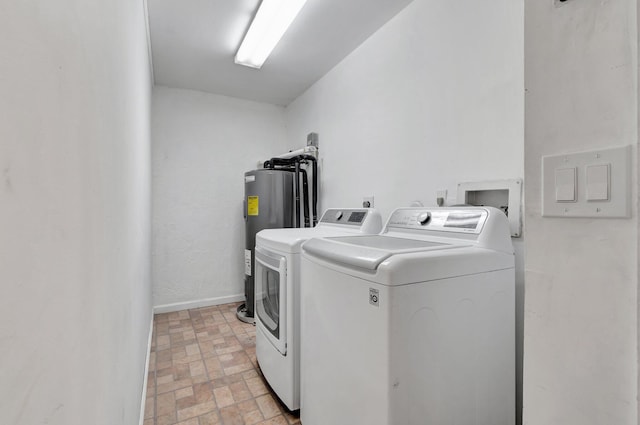 laundry area featuring separate washer and dryer and electric water heater