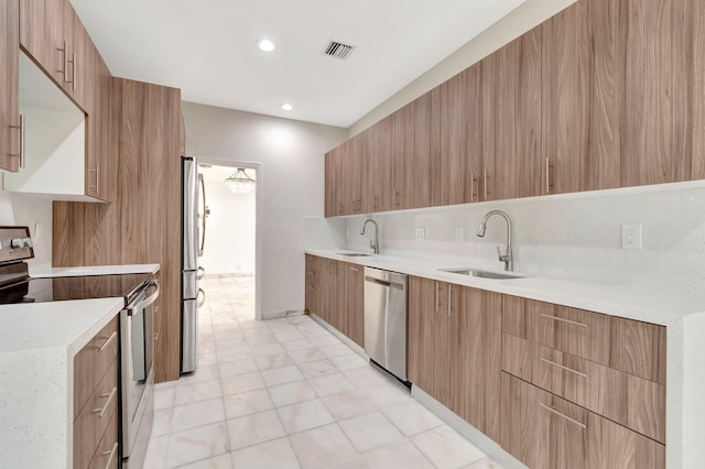 kitchen with tasteful backsplash, sink, and appliances with stainless steel finishes