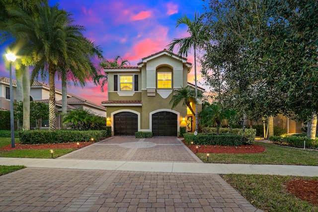 mediterranean / spanish house featuring a garage