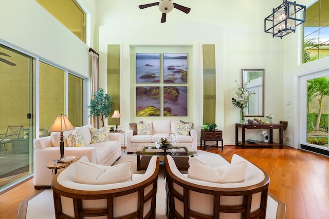 sunroom / solarium with ceiling fan with notable chandelier and a healthy amount of sunlight