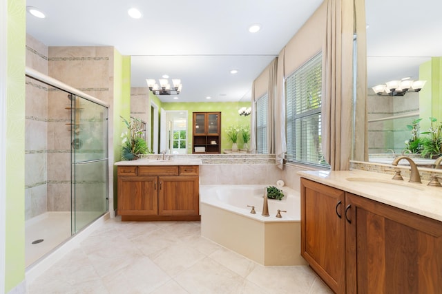 bathroom with tile patterned flooring, vanity, separate shower and tub, and a notable chandelier