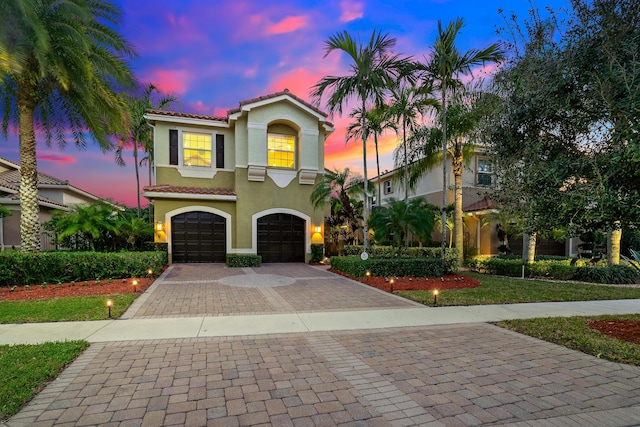 mediterranean / spanish home with a garage