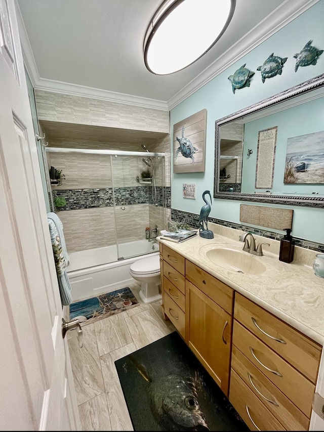 full bathroom featuring vanity, toilet, combined bath / shower with glass door, and ornamental molding