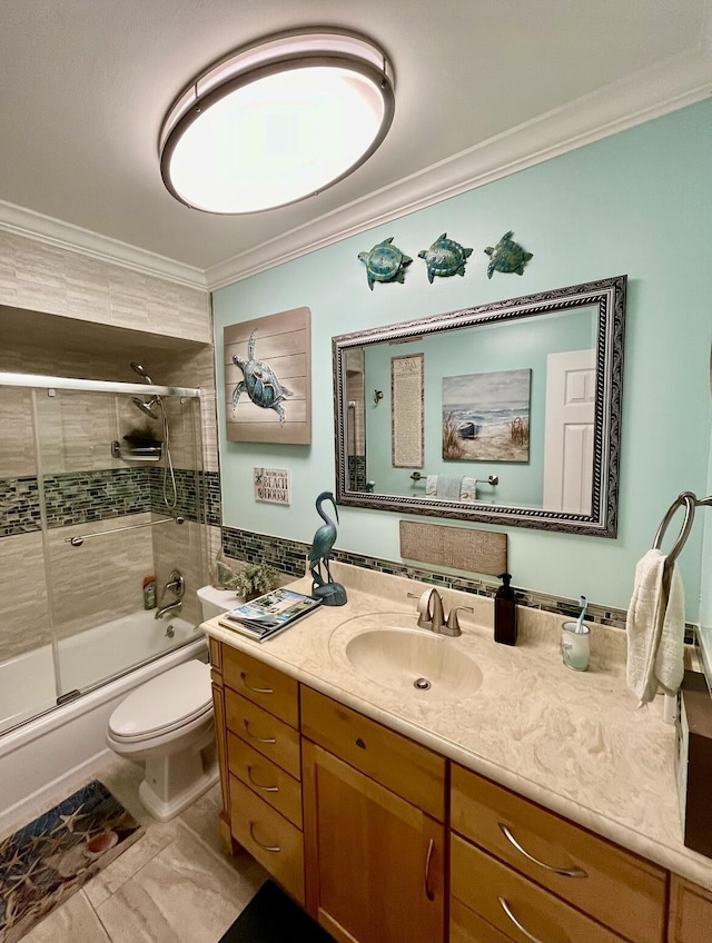 full bathroom featuring vanity, tile patterned flooring, toilet, enclosed tub / shower combo, and ornamental molding