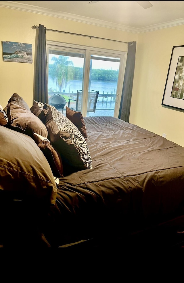 bedroom with access to exterior, ornamental molding, and a water view