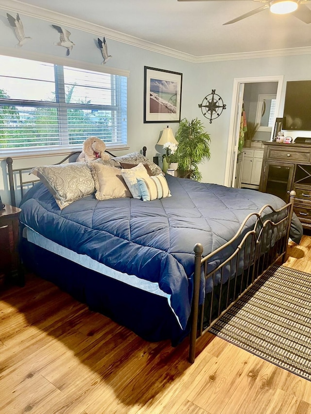 bedroom with ceiling fan, light wood-type flooring, and ornamental molding