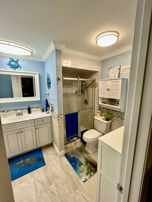 bathroom featuring vanity, toilet, an enclosed shower, and ornamental molding