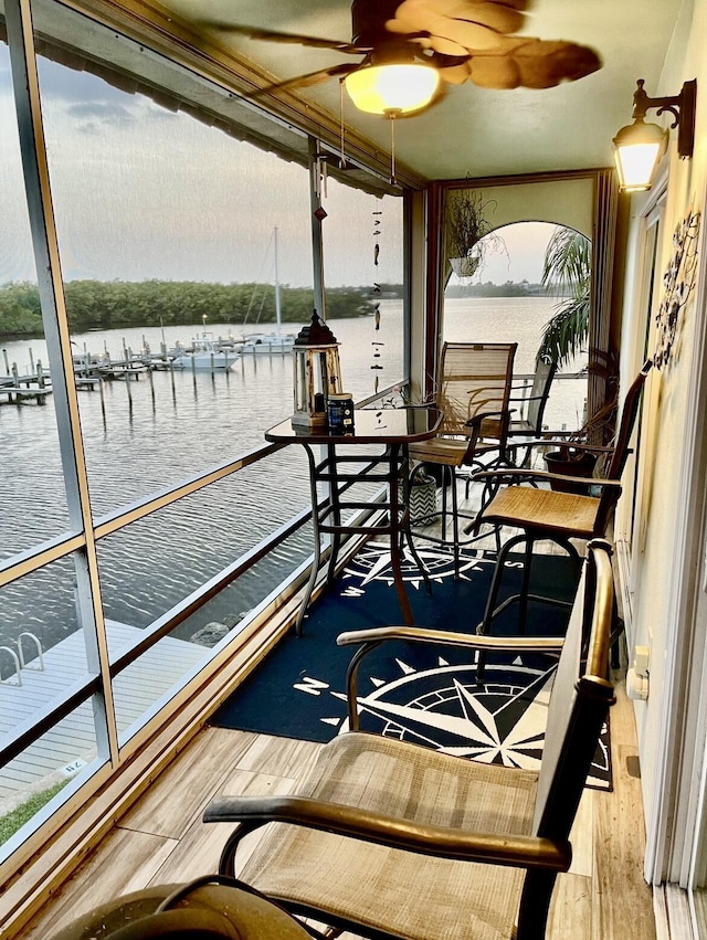 view of dock featuring a balcony and a water view