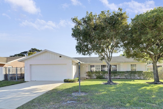 ranch-style house featuring a front lawn and a garage