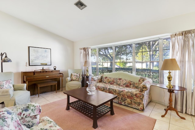 living room with light tile patterned flooring and vaulted ceiling